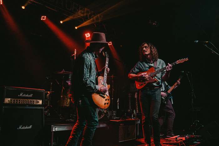 Guitarists performing on stage