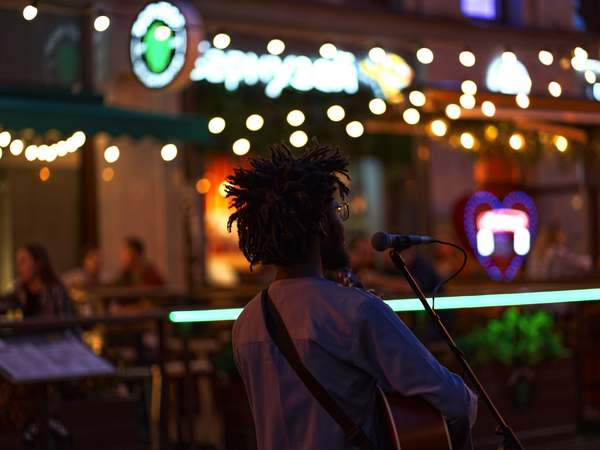Solo artist performing outside at night